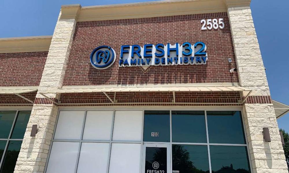 front door and sign at fresh 32 family dentistry