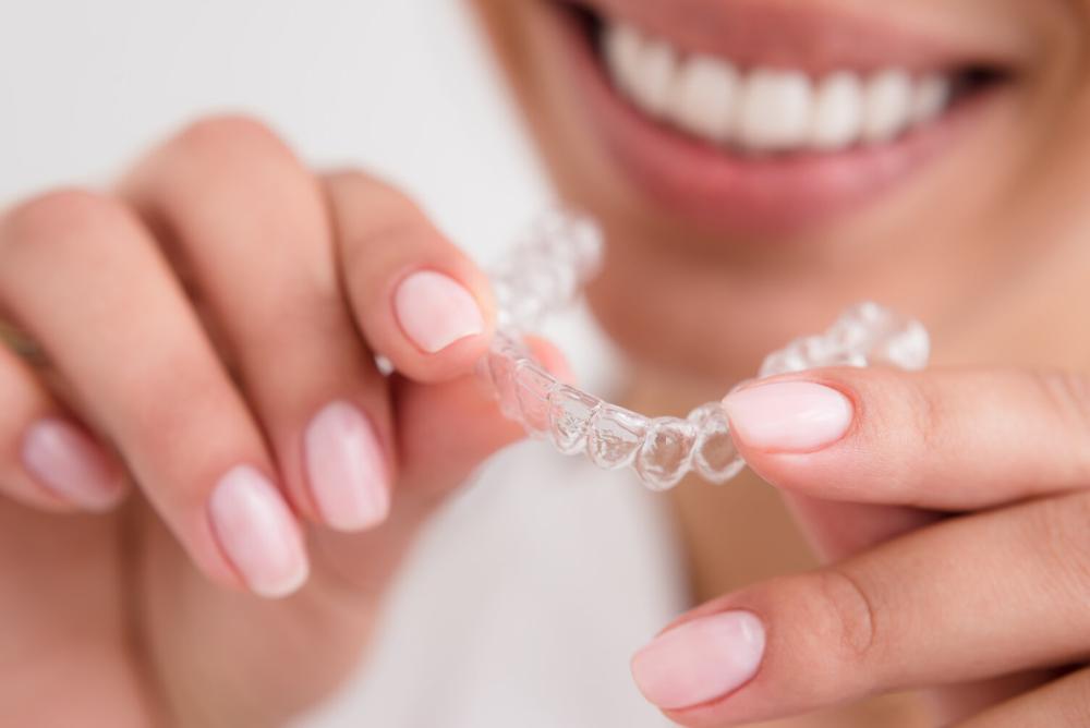 woman holding invisalign aligners 