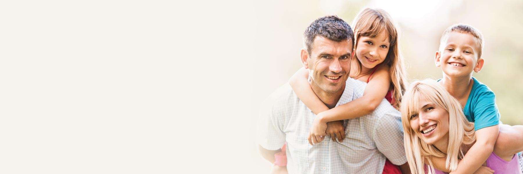 cosmetic dentistry mesquite | mom, dad, son, and daughter smiling