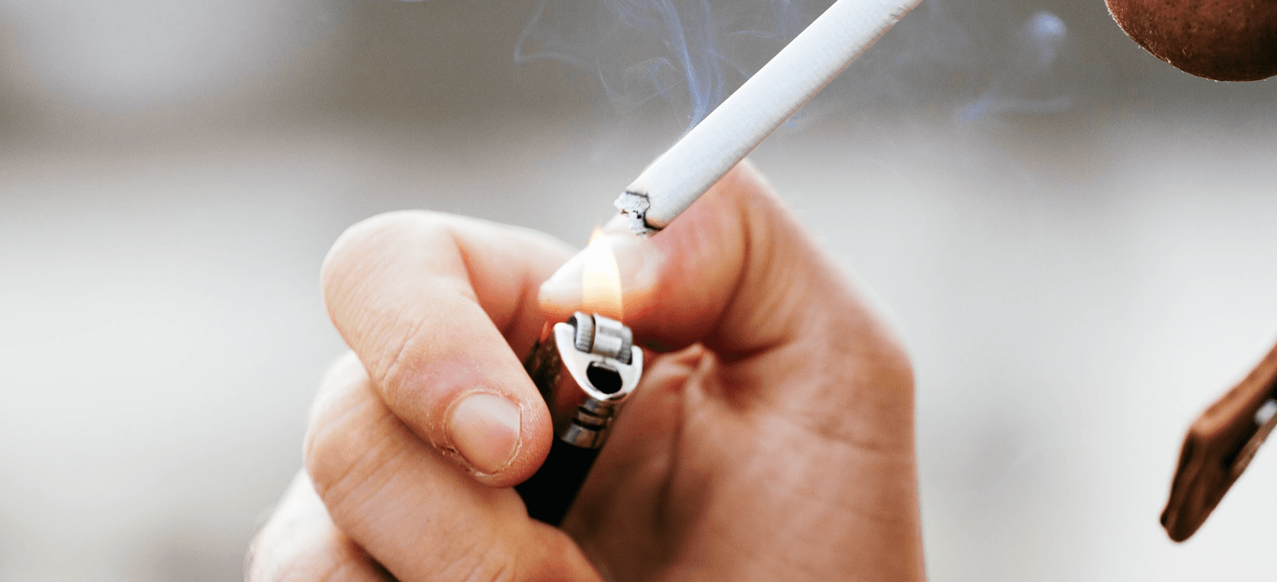 close up of person lighting a cigarette 