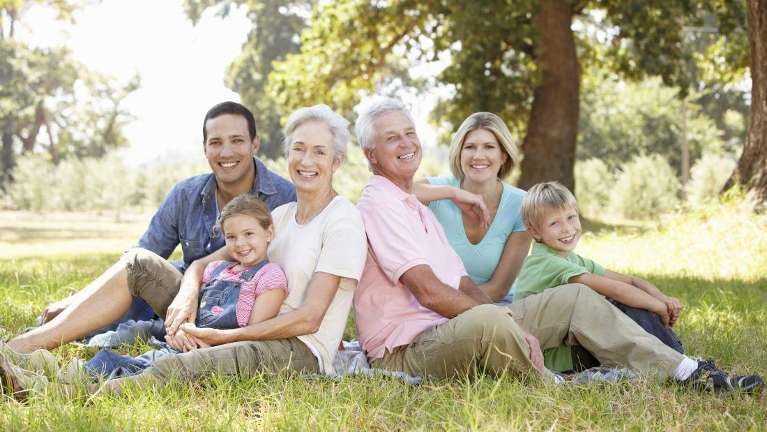 multigenerational family sitting in a park in mesquite tx