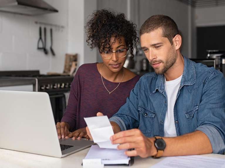 couple looking at laptop | dentist near me