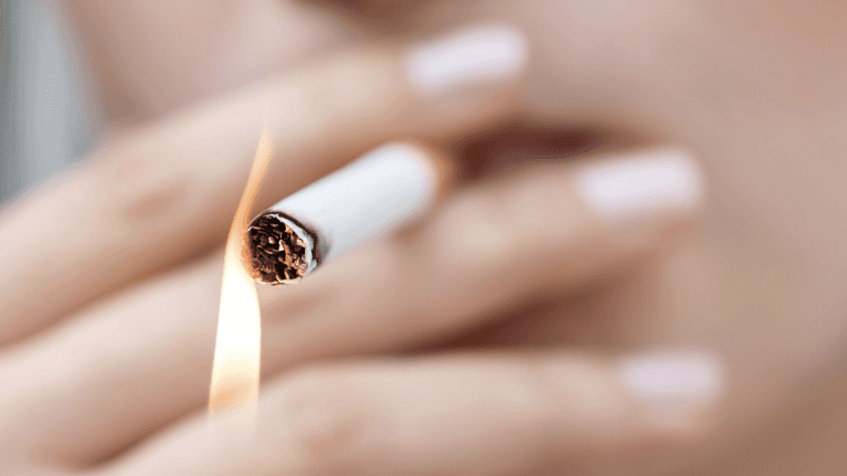 close up of person lighting a cigarette 