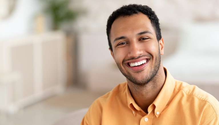 man smiling after getting crowns in mesquite tx