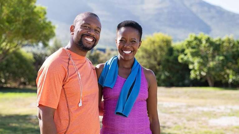 man and woman smiling after a work out