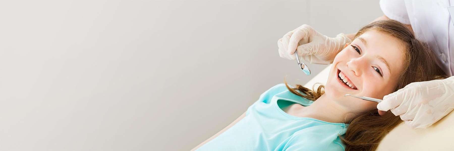 young girl smiling after getting tooth filling in a mesquite dental office